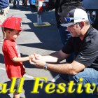 Prospective Lemoore Volunteer Fireman Ethan Decker gets some advice from Lemoore firemen Matt Moreno at Sunday's Fall Festival. 